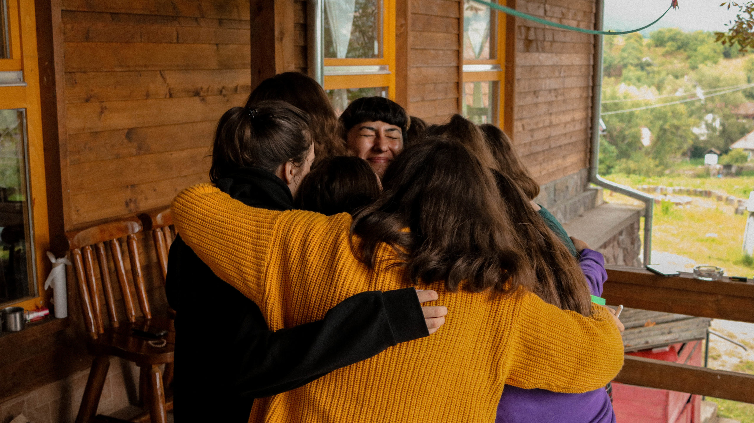 ROMANIA The Camp for Sisterhod participants group hug their self defense trainer scaled